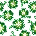 seamless pattern with green four-leaf clovers on a white background placed randomly Royalty Free Stock Photo